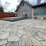 Patio made of stone assembled in random geometric shapes but fitting together like a puzzle.