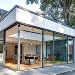 Glass ADU with dining area and large sliding glass doors.