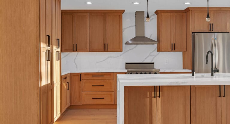 Kitchen with marble walls and island, all-wood cabinets